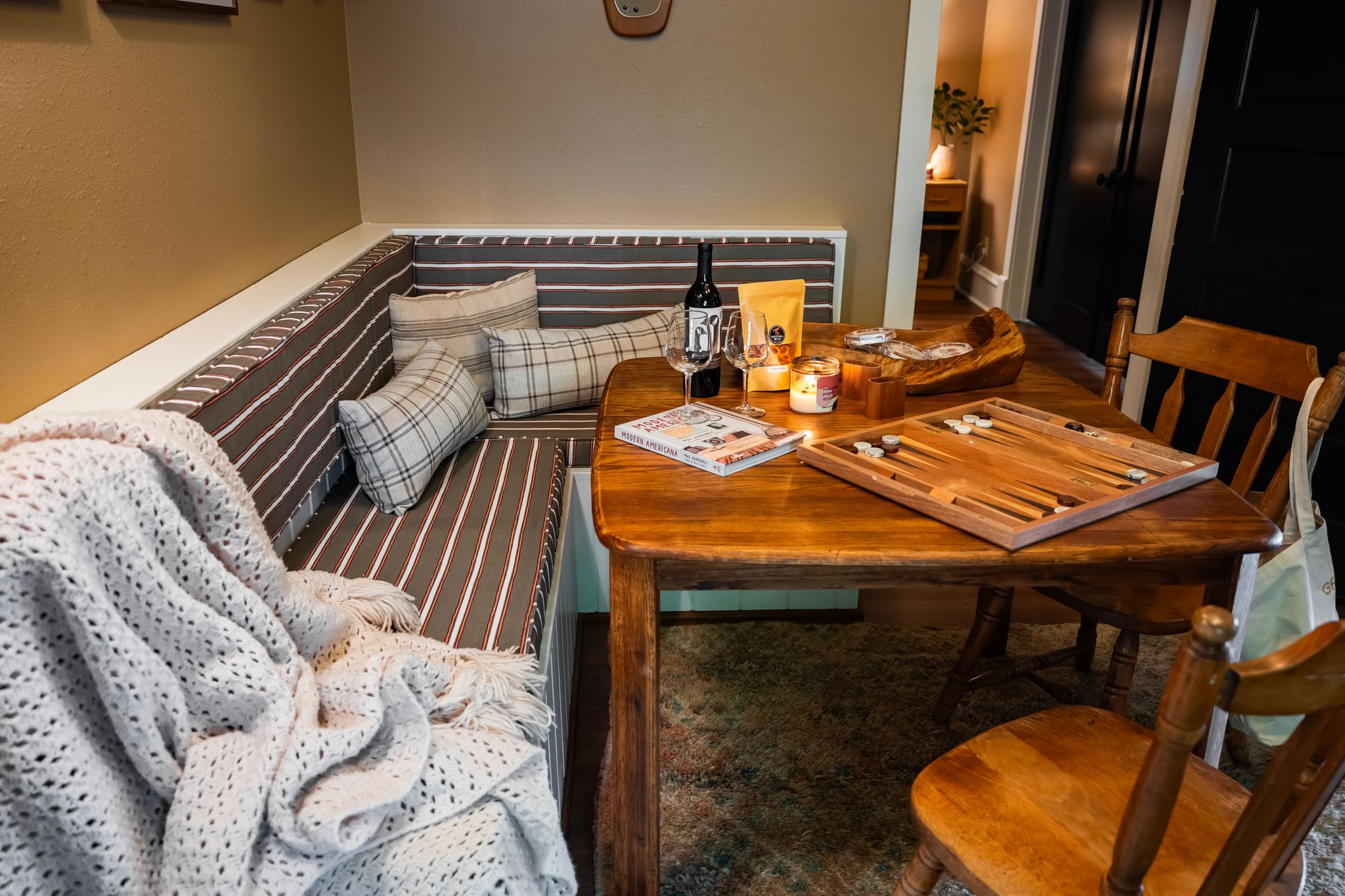 Dining nook with backgammon, wine, and cozy blanket